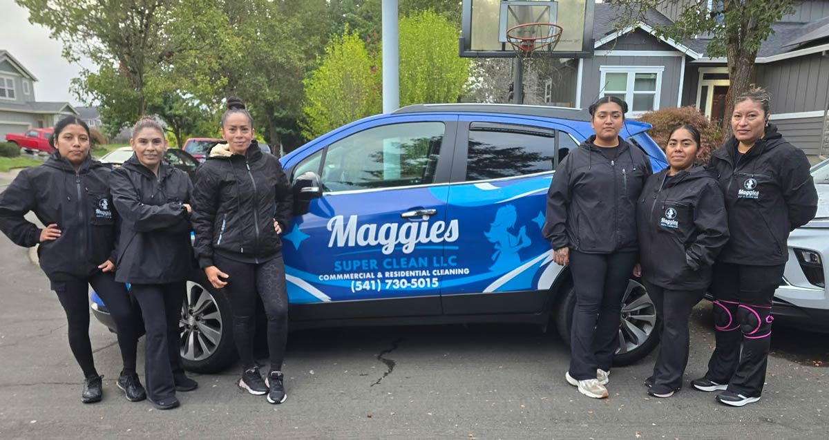 Maggie's Super Clean team standing beside the company vehicle