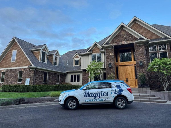 Maggie&rsquo;s Super Clean vehicle parked outside the large residential property served during the cleaning project.