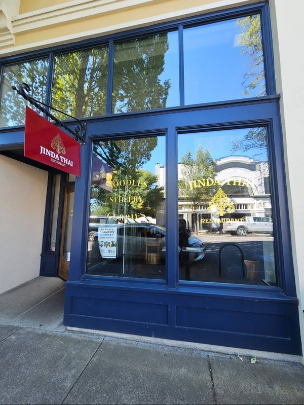 Jinda Thai Restaurant&rsquo;s storefront with clean glass entry doors and windows, clearly displaying the restaurant&rsquo;s exterior signage.