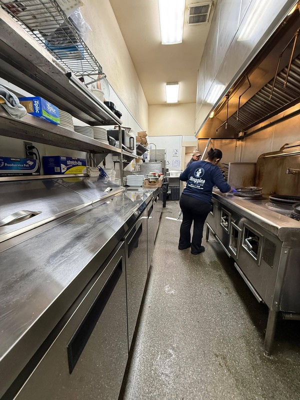 Maggie's Super Clean team members work along the stainless steel preparation and cooking surfaces in Jinda Thai Restaurant&rsquo;s commercial kitchen during the annual deep cleaning service.